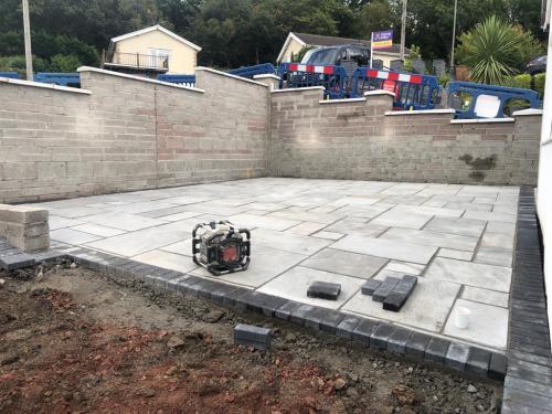 Light grey patio with dark grey brick border