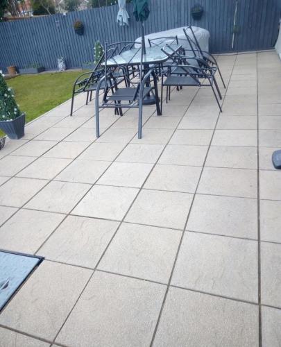Light grey square tiled patio in back garden