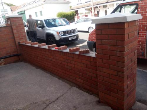 Newly built front garden red brick wall with pillars